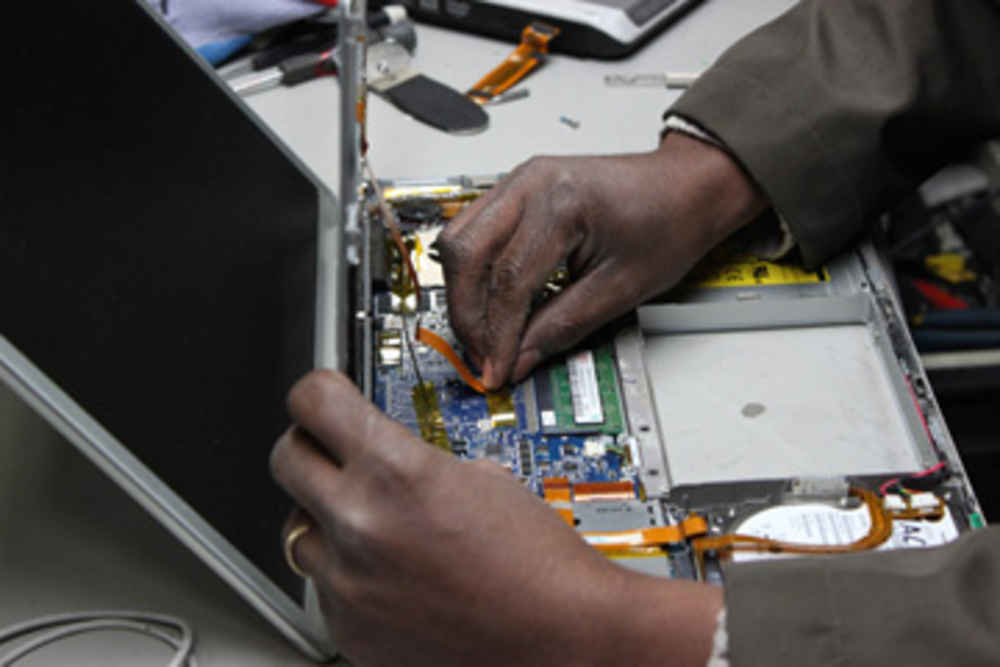 Man repairing laptop computer